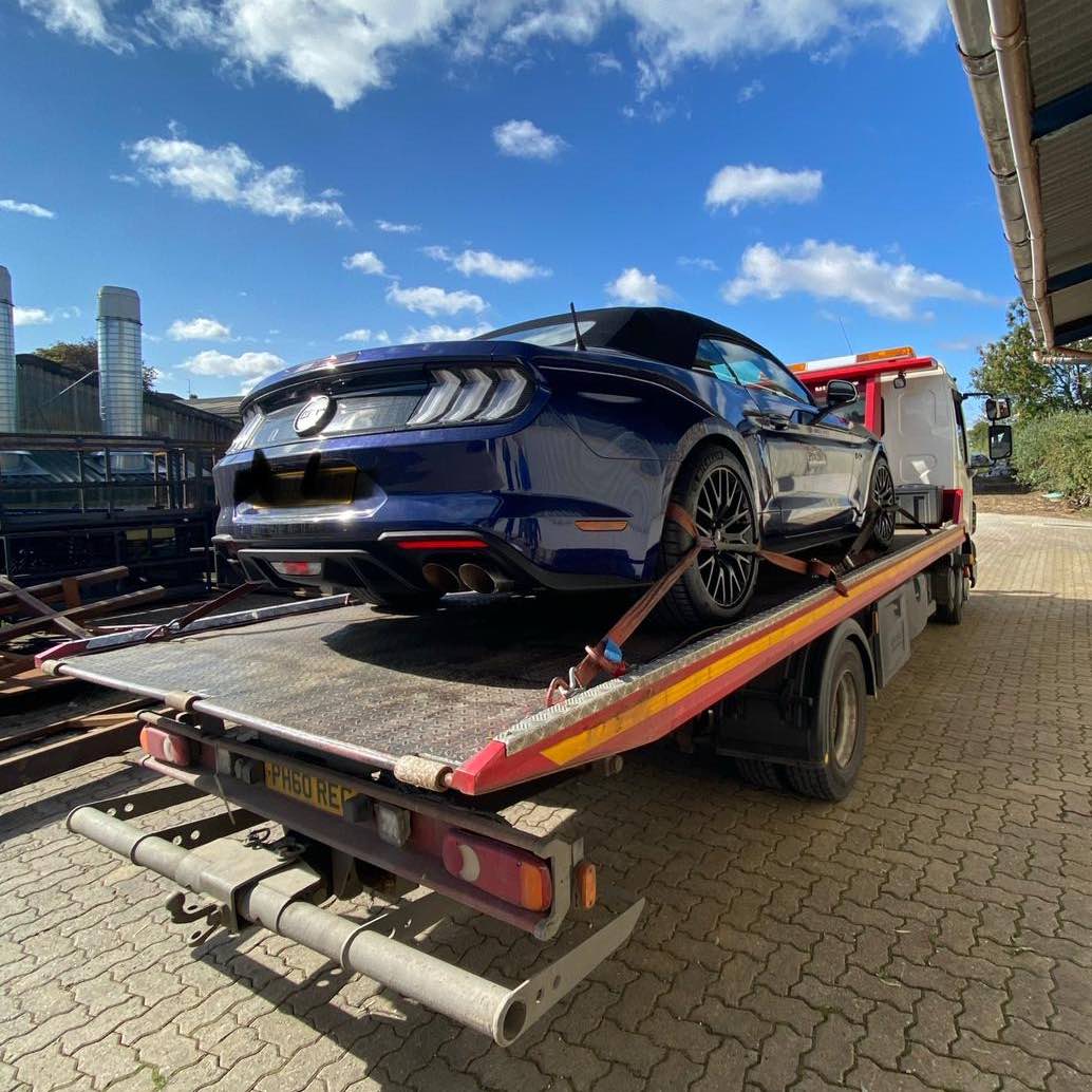 Car on back of recovery vehicle